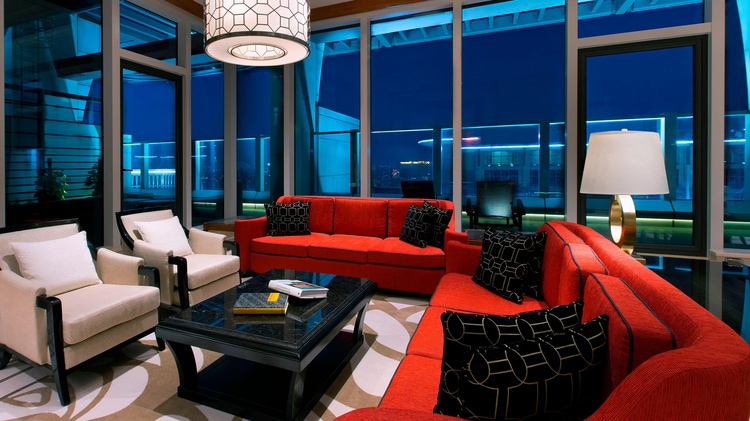 露台套房起居区，配有座位和红色沙发