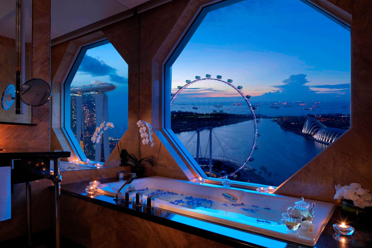 配备浴缸的大理石浴室，八角窗外是一览无余的新加坡摩天轮景观。