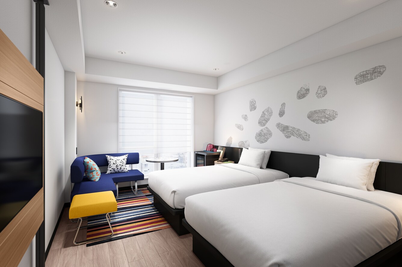Modern twin room with two beds and colorful sofa