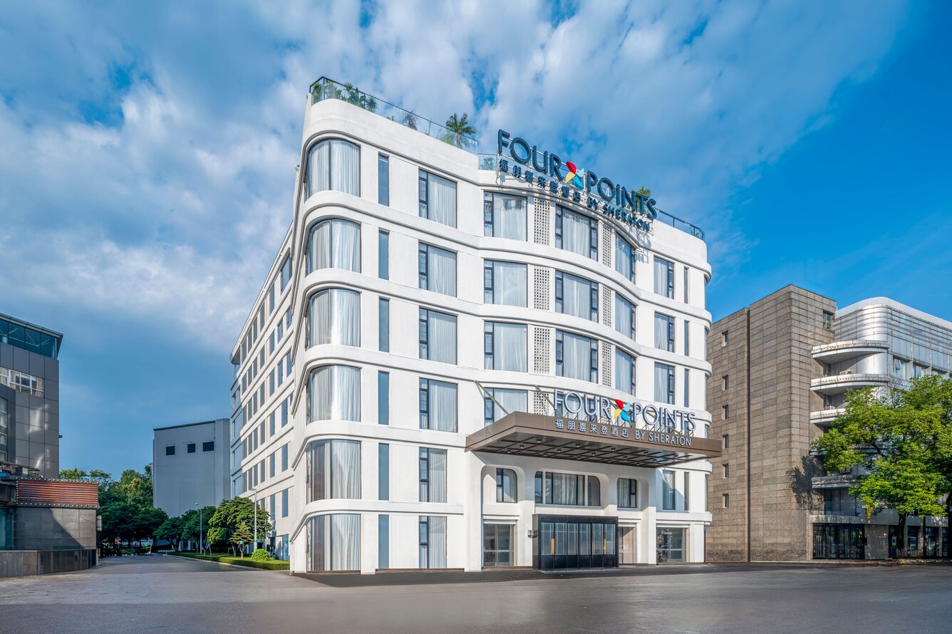 Modern white building exterior with signage