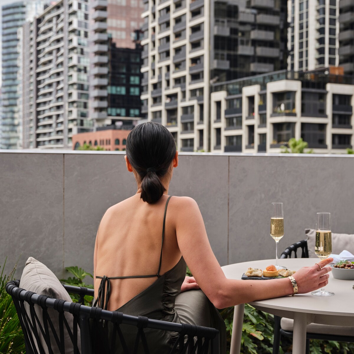 A lady sitting outisde on the M Club terrace