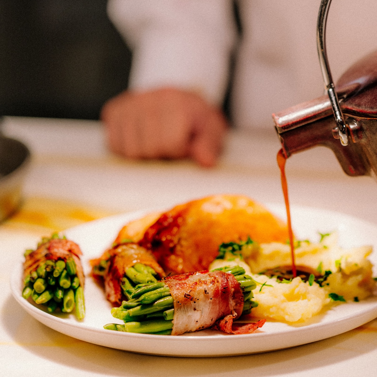 Chicken with mashed potatoes, bacon‑wrapped beans,