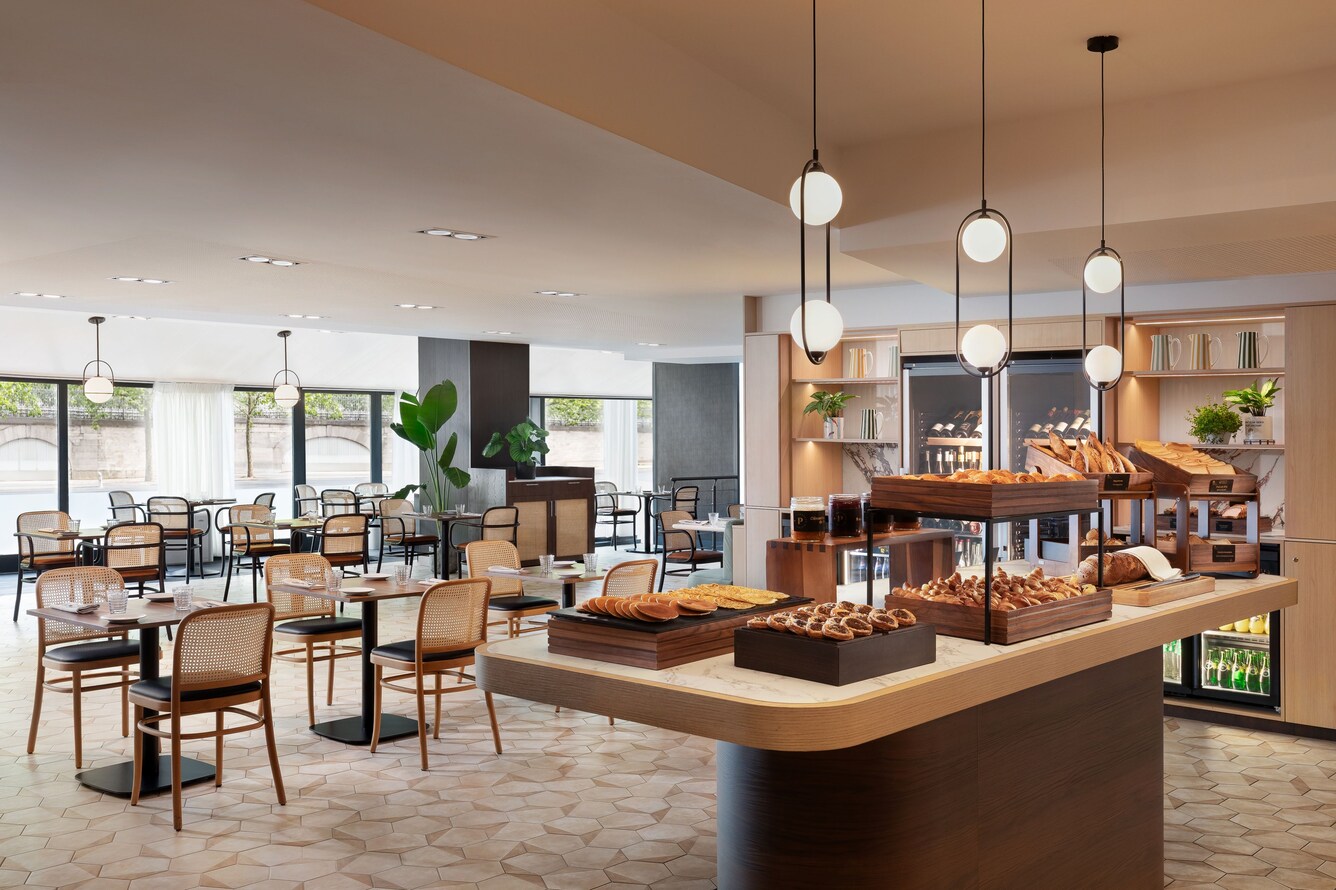 Breakfast buffet with pastries and dining tables