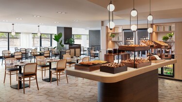 Breakfast buffet with pastries and dining tables