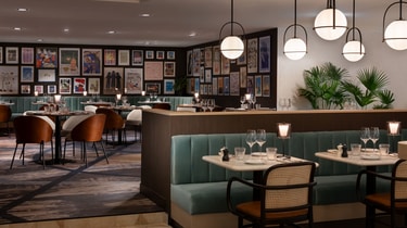 Palyma Bistro seating beside framed gallery wall