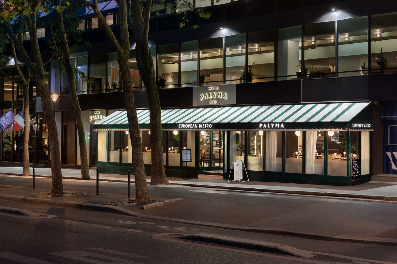 Illuminated Palyma Bistro exterior at night