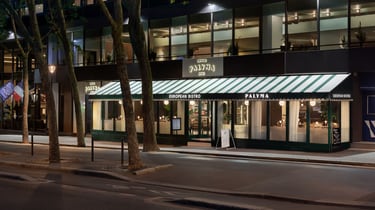 Illuminated Palyma Bistro exterior at night