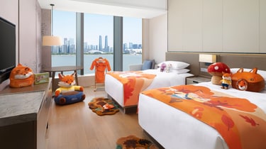 Twin guest room with fox theme and city view
