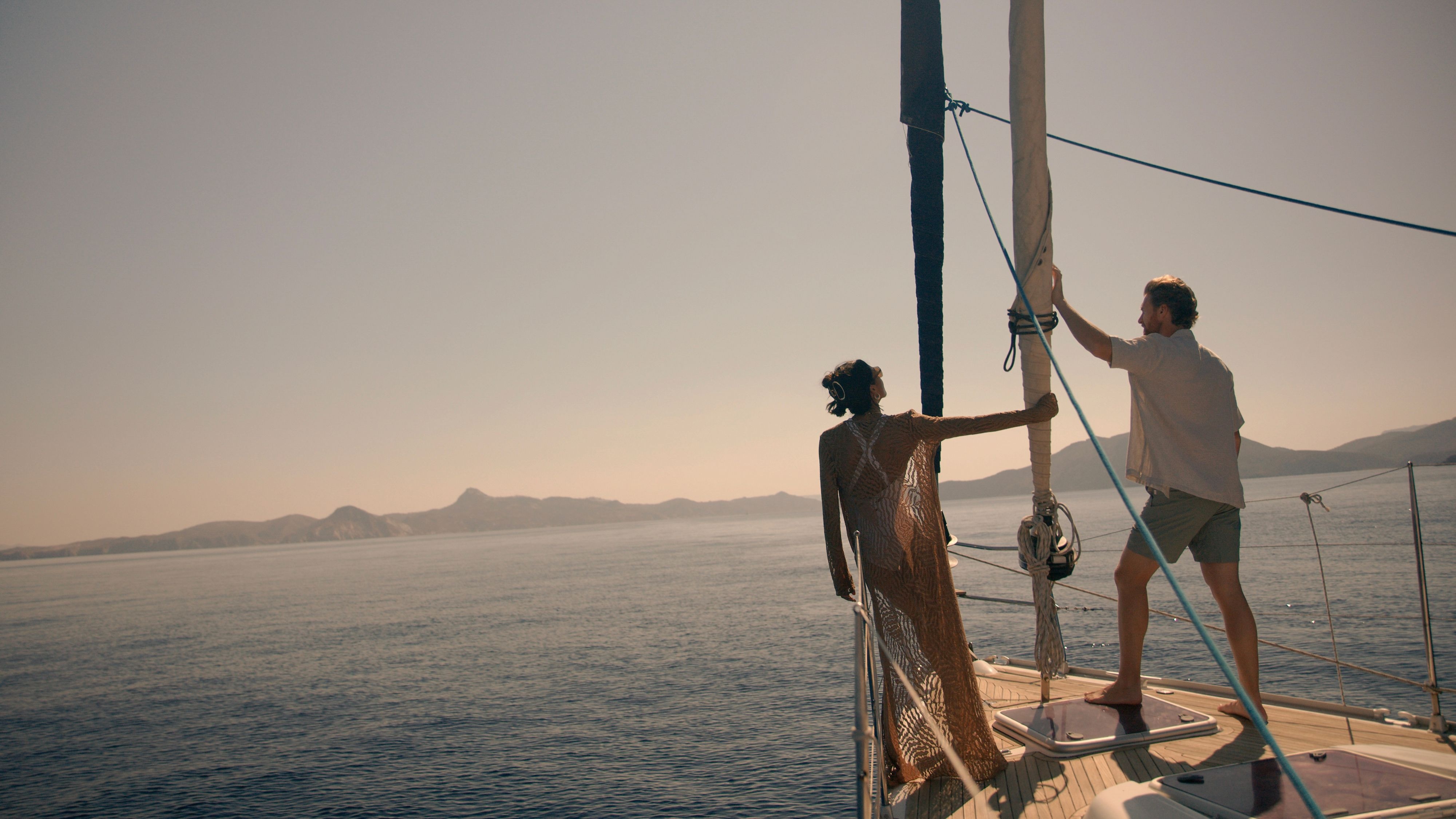 Couple sailing on small boat off the Greek Isles.