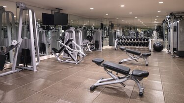 A fitness center with free weights and machine wei
