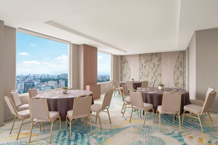 Banquet room with round tables and city views