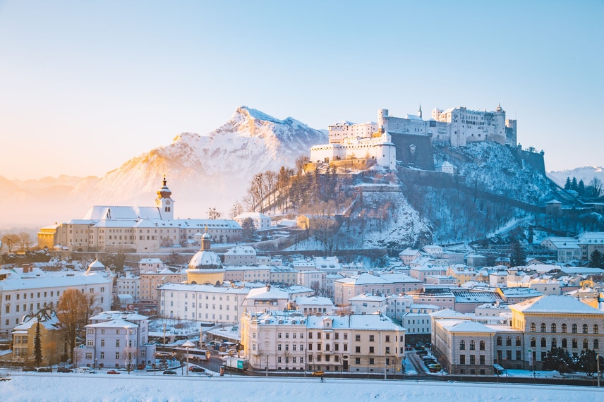 Snowy Salzburg old town and mountains.