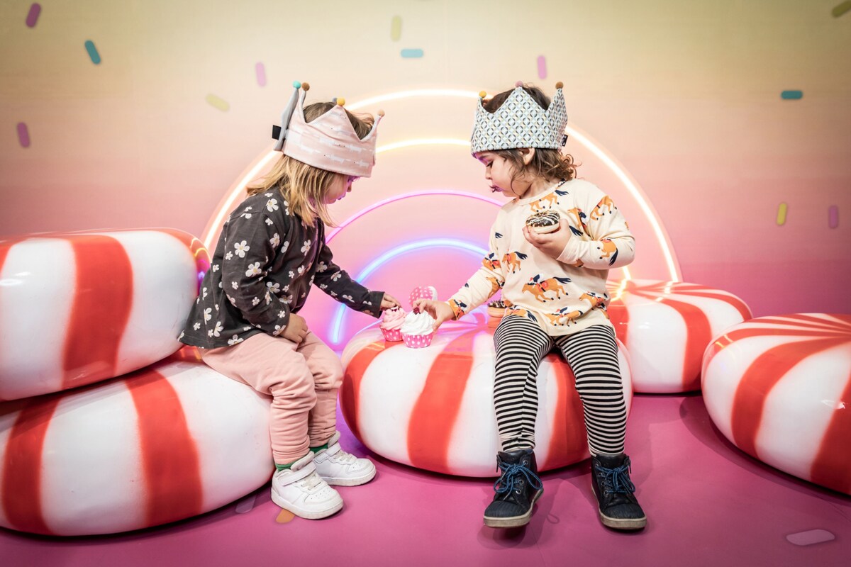 Little children having fun at a candy room.
