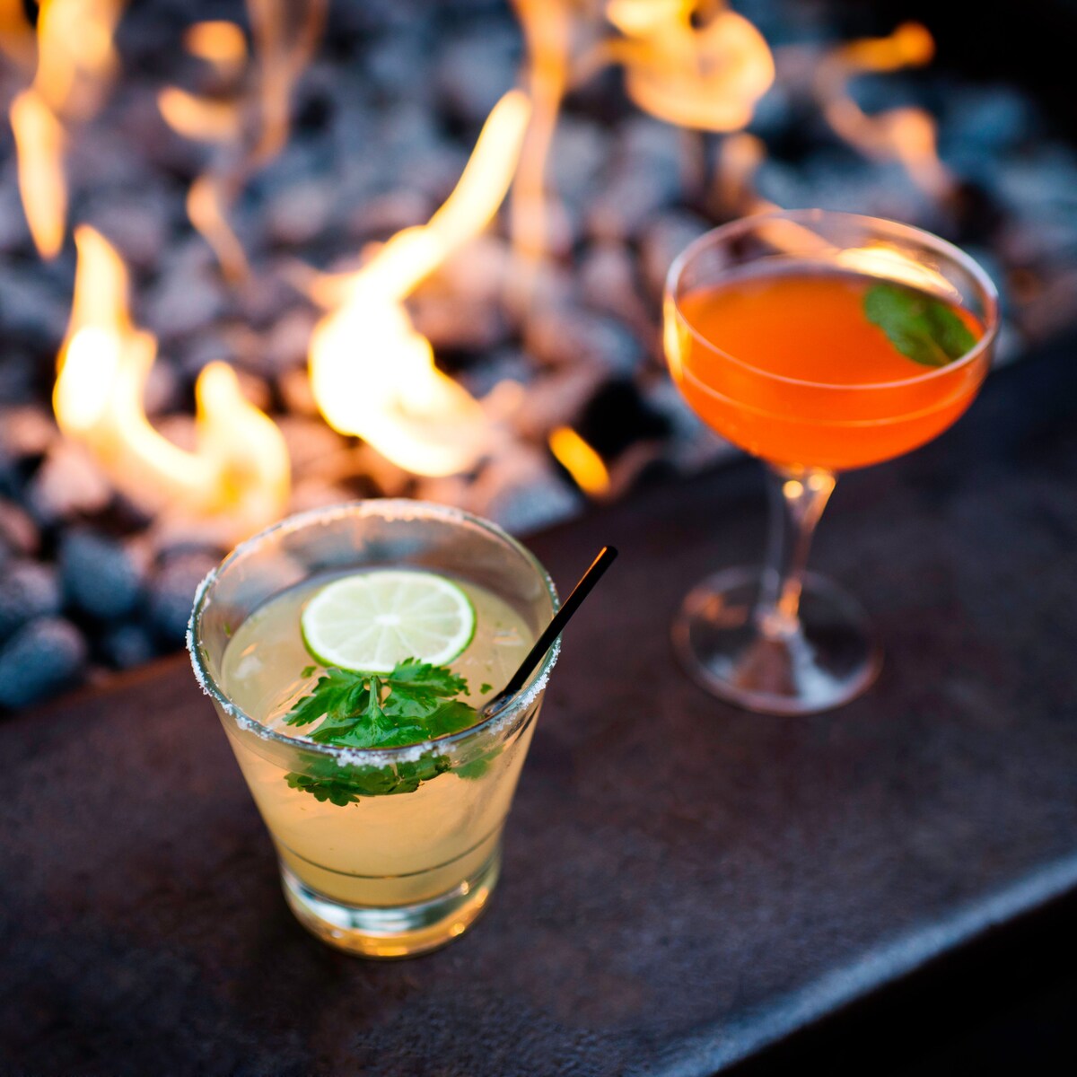 alcoholic beverages, close-up, cocktail glass, cocktail, comfort, drink, drinking straw, evening, fire, food industry, food, garnish, illuminated, low light, nobody, open fire, outdoors, restaurant, tumbler, two objects, warmth, Mill Valley, California, United States of America