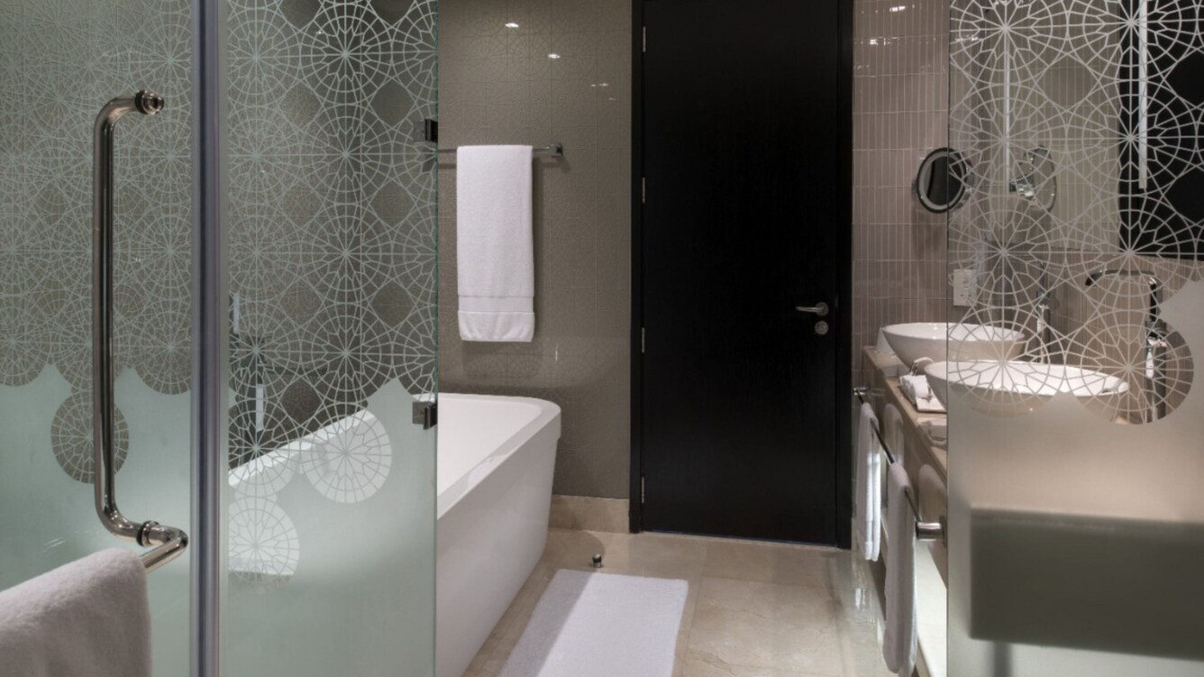 Bathroom with tub, shower and glass panels