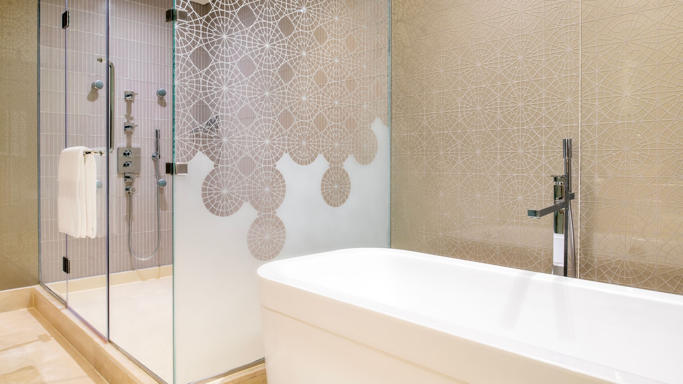 Bathroom with tub and glass walk‑in shower