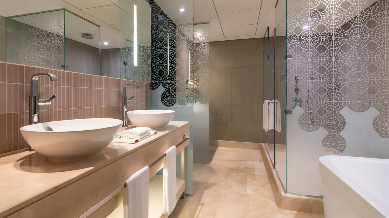 Bathroom with double sinks and glass shower