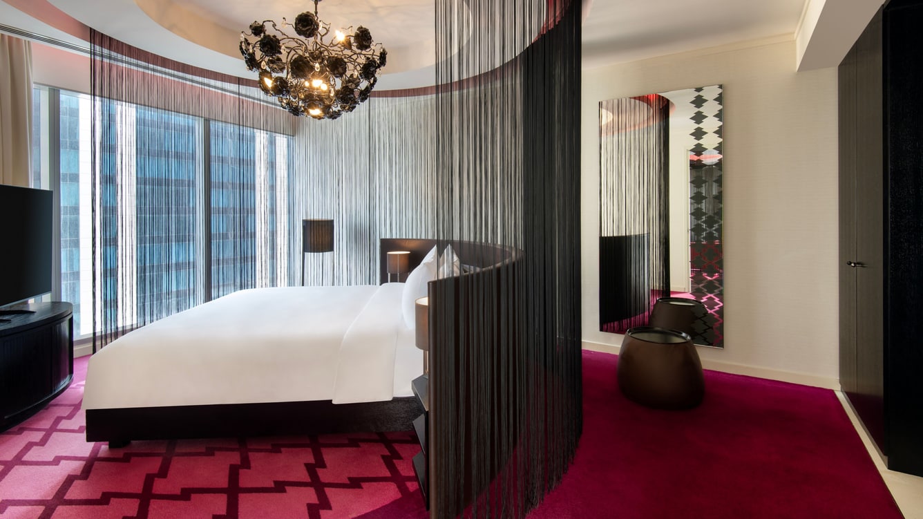 Bedroom with king bed and decorative chandelier