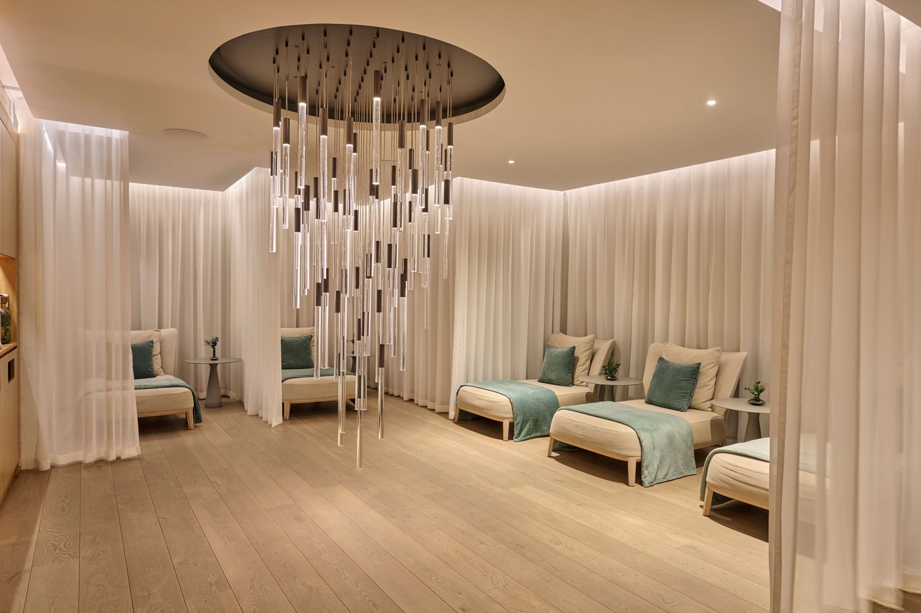 Six loungers with pillows and mesh curtains.