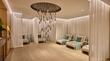 Six loungers with pillows and mesh curtains.