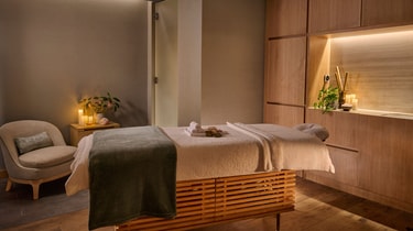 Spa treatment room with a massage bed