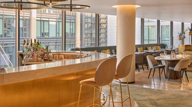 Bar area, tables, chairs, city view